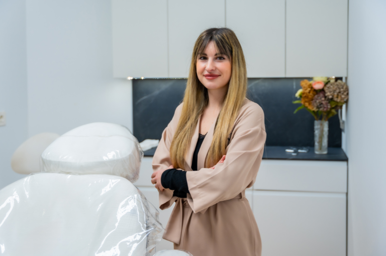 Professional wellness practitioner standing in a bright, modern treatment room